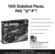 B&W half-page newspaper advertisement featuring Batman Lego set, with headline "1045 Diabolical Pieces. Holy *@#*!"