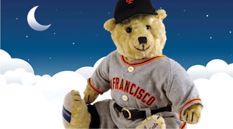 Teddy bear floating on clouds, wearing San Francisco Giants shirt and cap