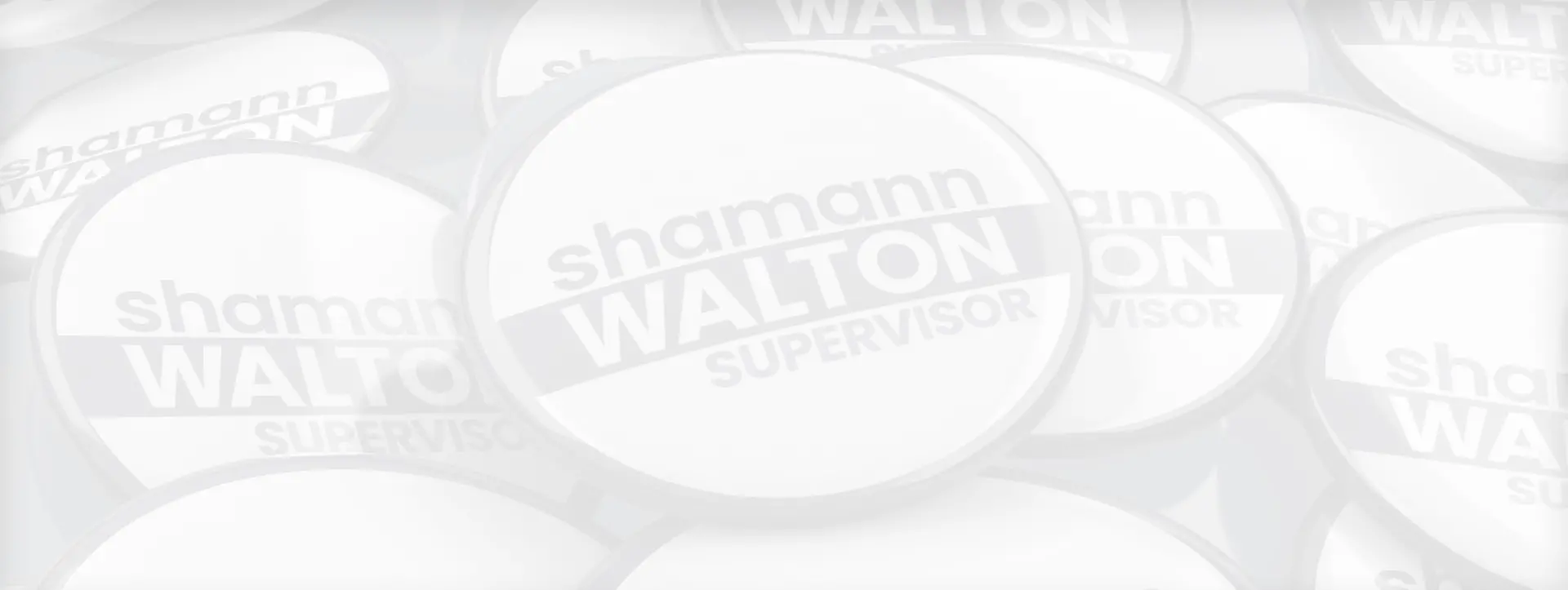 Faded black & white background image of several Shamann Walton election pin buttons